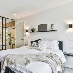 a bedroom with a large bed and ceiling fan