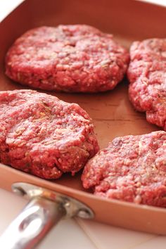 hamburger patties in a pan ready to be cooked