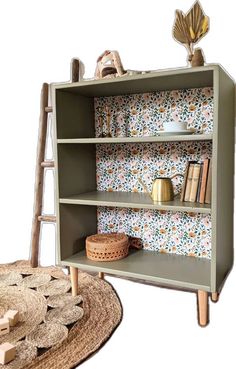 a book shelf with books on it next to a place mat and rug in the shape of a ladder