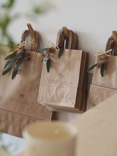 three brown paper bags hanging on the wall