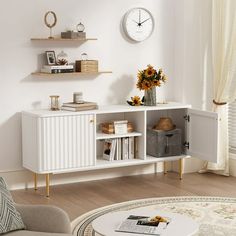 a living room filled with furniture and a large clock on the wall above it's shelf