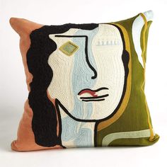 a decorative pillow with an image of a woman's face on it