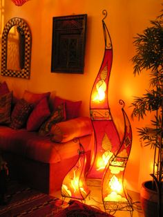 a living room filled with furniture and lit candles