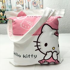 Hello Kitty Tote Bag, Size 39cm/ 15in Length X 33cm/ 12.5in Wide Hello Kitty Print School Bag, Rectangular, Hello Kitty Print School Bag, School Bag With Hello Kitty Print, School Bags With Hello Kitty Print, Rectangular Shape, White Kawaii Canvas Bag As Gift, Hello Kitty Rectangular Shoulder Bag For Daily Use, Kawaii White Canvas Bag For Everyday Use, White Bag With Cat Design For Gift, Kawaii White Gift Bag