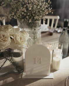 the table is set with flowers and candles