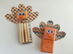 two turkeys made out of popsicle sticks are sitting next to each other