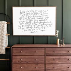 a wooden dresser sitting next to a green wall