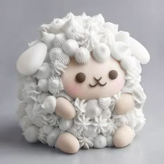 a white sheep with flowers on it's head sitting in front of a gray background