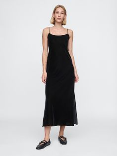 Soft, smooth velvet maxi slip dress.  Scoop neck.  Adjustable spaghetti straps.  Slit at hem.  This dress is made with 100% recycled polyester.  Compared to virgin materials, using recycled materials helps to reduce resource use and waste.  Fit: Slim.  An A-line silhouette that sits close to the body with a flared opening.  Models wearing Gap Black Tea Dress, Sleeveless Velvet Dress, Black Velvet Maxi Dress, Rush Outfits, Slip Dress Black, Velvet Maxi Dress, Velvet Maxi, Shoe Inspo, Maxi Slip Dress