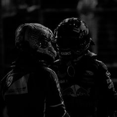 two men in racing gear standing next to each other