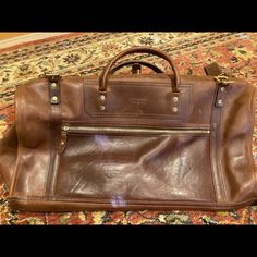 Never Used J. W. Hulme & Co. Brown Leather Duffle Bag. It Is Leather - And Hence Has Normal Discolorations And Slight Markings. Purchased A Few Years Ago For Over $1100. Asking $800 Or Best Offer. Leather Top Handle Duffle Bag, Classic Satchel With Dust Bag For Errands, Leather Top Handle Duffle Bag For Errands, Leather Duffle Bag With Top Handle For Errands, Luxury Rectangular Duffle Bag For Errands, Elegant Rectangular Duffle Bag For Errands, Leather Duffle Bag With Leather Handles For Errands, Leather Satchel Travel Bag With Dust Bag, Designer Travel Shoulder Bag With Leather Backing