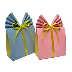 two small gift bags with bows on them