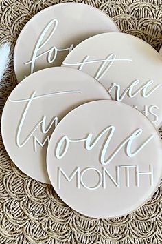 three white ceramic coasters with the words, do it now and one month written on them