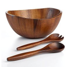 two wooden spoons and a bowl on a white background