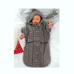 a baby is laying down wearing a coat