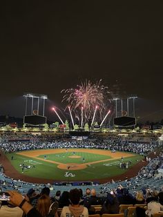 fireworks light up the night sky over a baseball field