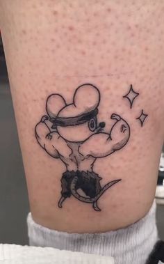 a person with a tattoo on their leg that has an image of a cartoon character