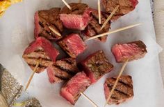 steak skewers are sitting on top of paper