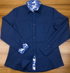 Chic and smart too! This stunning navy-blue cotton twill shirt is contrasted with a tremendous delft blue floral design to make this a great everyday wardrobe staple. Darted front and back provide a more tailored and figure-hugging look. DETAILS Material (100% micro twill cotton) Turn back Cuffs Contrasting color and cuffs Anti-gape Button placket Care (Machine wash at 30°) Country of Origin (Thailand) Blue Fitted Cotton Dress Shirt, Fitted Blue Cotton Dress Shirt, Blue Fitted Shirt With Spread Collar, Classic Indigo Shirt For Work, Navy Fitted Tops With Spread Collar, Navy Fitted Top With Spread Collar, Elegant Navy Cotton Shirt, Fitted Blue Shirt For Semi-formal Occasions, Classic Fitted Navy Dress Shirt