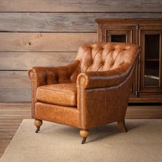 a brown leather chair sitting on top of a rug