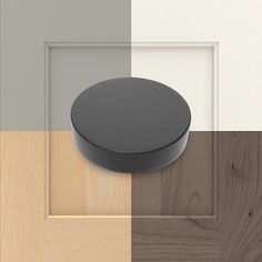 a round object is placed on the side of a door with wood paneling in different colors