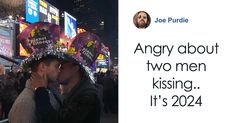 two men kissing each other in the middle of a crowded street at night, with an ad for joe purdie