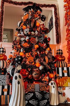 a decorated halloween tree with pumpkins and ghost decorations