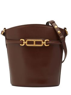 Height: 26cm Width: 27cm Depth: 14.5cm. Strap drop: 25cm. Adjustable leather strap. Front strap with gold-colored metal logo detail Ski Accessories, Saddle Brown, Leather Bucket Bag, Leather Bucket, Metal Logo, Black Iron, Metallic Logo, Luggage Bags, Tom Ford