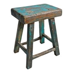 an old wooden stool with blue paint on it