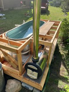 a boat made out of pallet wood with a metal tank attached to the side