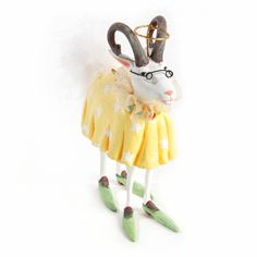 a white rabbit wearing a yellow dress with stars on it's head and legs