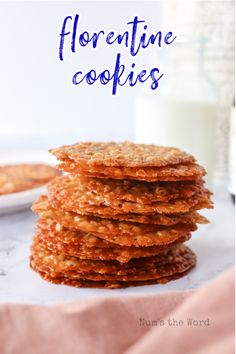 a stack of cookies sitting on top of a table next to a glass of milk