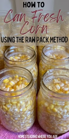 mason jars filled with corn sitting on top of a pink towel and text overlay reads how to can fresh corn using the raw pack method