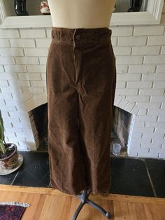 Here is an amazing pair of vintage corduroy pants from the 1970s. Rich brown color with gold snap at the front over a zipper. Four sets of double belt loops around the waist. No pockets add to the clean lines. Slight flare at the bottom of the leg. Nothing super fancy, just timeless looks and comfort. They are in excellent condition with years of life left! Here are the measurements taken laying flat: Waist: 14" Width of one leg (mid thigh) 10" Length: 40" Vintage Brown Corduroy Bottoms, Retro Corduroy Pants With Pockets, Retro Full-length Corduroy Pants, Retro Full Length Corduroy Pants, Vintage Corduroy Straight Leg Bottoms, Vintage Corduroy Pants With Pockets, Vintage Straight Leg Corduroy Pants, Vintage Straight Leg Corduroy Bottoms, Retro High-waist Corduroy Pants