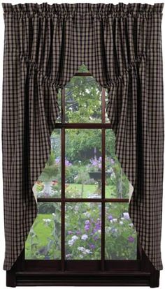 a window with a curtain and some flowers outside