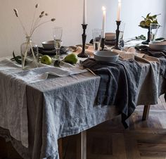 the table is set with plates and glasses