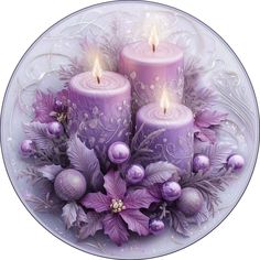 three candles with purple flowers on a plate