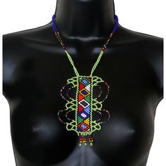 NECKLACE DESCRIPTION  African boho style fantasy jewelry. African necklace adorned with a fancy pendant decorated with Zulu ethnic motifs. Made up of light green and multi-colored seed beads slipped onto nylon threads, it fastens with a ball clasp. This necklace is 33cm long, the chain length is 46cm and the pendant is 12cm long and 8cm wide.  COLORS  Light green - Multicolor  NECKLACE DIMENSIONS IN CM AND INCHES  - Chain length: 46 cm (18.11'') - Length (from neck to pendant): 33 cm (13.38'') - Fancy Pendant, African Crafts, African Necklace, African Jewelry, Necklace Boho, Zulu, Fantasy Jewelry, Boho Stil, Ethnic Jewelry