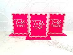 three pink greeting cards with the words table two and one