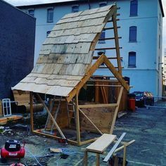 a small wooden house being built in the yard