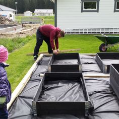 two children and an adult are working on some construction