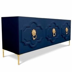 a blue cabinet with gold handles and lions on it