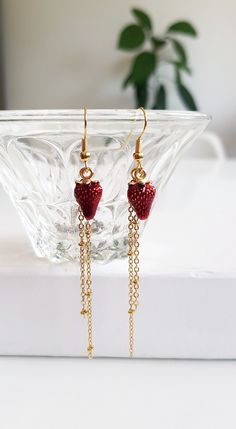 "Strawberry Fruit Chain Earrings for your daily dose of quirky and fun { D e s c r i p t i o n } These earrings have all it takes to make an appearance! With a simple design, they are made with gold plated chains and a enamel strawberry pendants. The satellite chains dangles gently,  framing and elongating your face. They have a gorgeous gold finish and are made of brass. The golden French hooks accessories are gold plated. Rubber back stoppers included. Perfect to wear daily on hot summer days, to gift it to a gardening lover or even someone who enjoys fruits and quirky accessories.   { Si z e } 8 cm / 3.2\"  long 1.2 cm strawberry pendants  please note, jewelry might change color due to moist and chemical exposure. Wipe with a soft cotton cloth and avoid exposure to elements  ♥ Please re Quirky Accessories, Cottagecore Earrings, Quirky Jewelry, Fruit Jewelry, Strawberry Fruit, Summer Fruit, Fun Summer, Chain Earrings, Gold Plated Chains