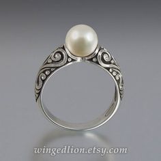 "BEATRICE ring is made to order in 14K gold in the size specified by the customer. The shank is adorned with intricate scroll carvings. The ring features a beautiful 7.5mm White Akoya Pearl. The crown is about 8mm high (including the stone) and 7.5mm wide. The widest part of the shank is 5.9mm. The ring can be made in sizes from 4 to 9. The sample ring shown in the photos is size 6.75. The ring is shown with an antique tarnishing, which adds depth and brings out the beautiful carvings. If you ra Akoya Pearls, Gold Engagement Ring, Gold Engagement, Gold Engagement Rings, Pearl Jewelry, Ring Verlobung, Statement Rings, Silver Bracelet, Engagement Ring