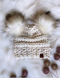 This is a super warm chunky knit hat made with 20% wool blend yarn. Ivory hat Topped with two removeable super soft and fluffy faux fur poms. Hat can be washed once poms are removed. Lay flat to dry. Poms can be fluffed up by using a hair dryer on high for a few seconds. Can be made in other color. Please message me! Winter Cream Crochet Hat With Soft Knit, Cream Crochet Winter Hat With Soft Knit, Cream Soft Knit Crochet Hat For Winter, Cozy White Crochet Hat, Warm Cozy White Crochet Hat, Cozy Warm White Crochet Hat, Cozy White Hat, White Crochet Winter Hat For Cold Weather, Cozy White Crochet Hat For Winter