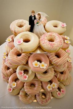 a wedding cake made to look like donuts and doughnuts are stacked on top of each other