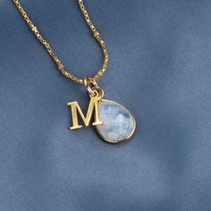 This genuine moonstone birthstone necklace symbolises happiness and self-confidence. Our 18 carat gold vermeil pendant features a real moonstone gemstone at its centre.  Our real moonstone gemstone is carefully cut in facets to show off the light-reflecting properties of the stone.  DETAILS:  * Real Moonstone gemstone. *  Crafted in 18 carat gold vermeil * Moonstone gemstone measures 13mm x 10mm. * Can be personalised with your initial charm.  * Chain: Choose from 16, 18, 20, 24 and 30 inch medi Gold Moon Shaped Gemstone Necklace, Gold Moonstone Pendant Necklace, Gold Moonstone Necklaces For Anniversary, Gold Moonstone Necklace With Moon Charm, Gold Moonstone Necklace For Anniversary, Gold Moonstone Necklace As Gift, Dainty Moonstone Charm Necklace For Gift, Gold Moonstone Necklace For Gift, Yellow Gold Moon Shaped Jewelry With Birthstone