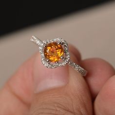 This is a gorgeous handmade creation. Its beauty is its simplicity & Elegance. The 6*6mm round cut natural citrine is crafted in solid sterling silver and with rhodium plated. It is available to customized, if you have any mind, just let me know, we will discuss with it. All item is sent in a beautiful gift box You can realize more lovely stuff clicking the link https://www.etsy.com/shop/knightjewelry?refshopsection_shophome_leftnav Please leave the correct address and you PHONE NUMBER for d White Gold Citrine Jewelry With Center Stone, White Gold Citrine Jewelry With Halo Setting, Yellow Topaz Ring With Center Stone In Sterling Silver, Orange Round Yellow Sapphire Jewelry, Elegant Silver Citrine Birthstone Ring, White Gold Citrine Jewelry With Accent Stones, Elegant Citrine Crystal Ring With Birthstone, Silver Citrine Promise Ring, Citrine Birthstone Jewelry In Round Cut