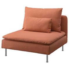 an orange couch with two pillows on it's back and one arm resting against the pillow