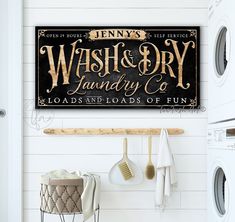 a wash and dry sign hanging on the wall next to a laundry room with washing machines